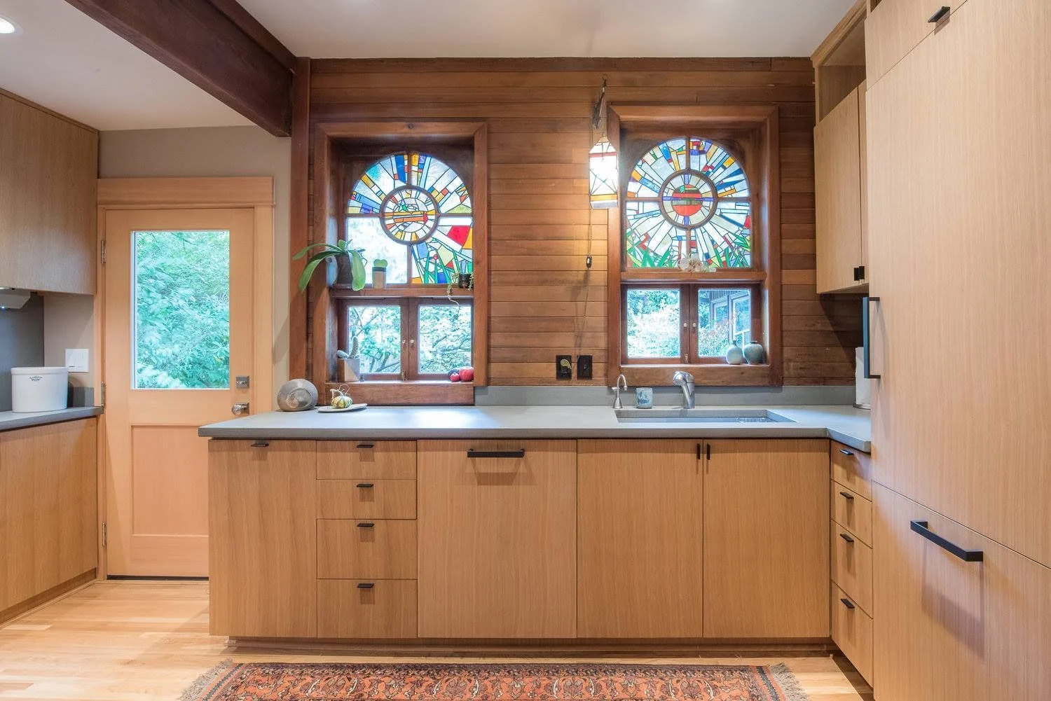 Kitchen sink wall under original arched stained glass